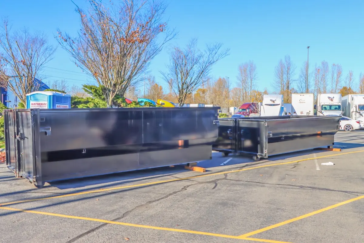 Professional dumpster rental service with roll-off container on residential driveway in Dana Point